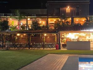 a building with a restaurant at night at Casa do Lago in Amarante