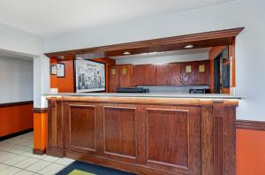 a kitchen with a wooden bar in a room at Super 8 by Wyndham Johnson City in Johnson City