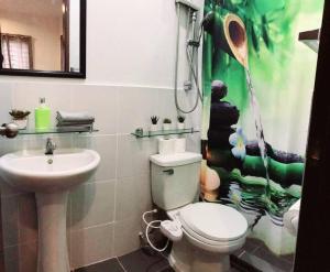 a bathroom with a toilet and a sink at Home away from home. in Bacolod