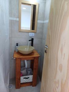 a bathroom with a sink and a mirror on a table at Lo de Tomy in Río Grande