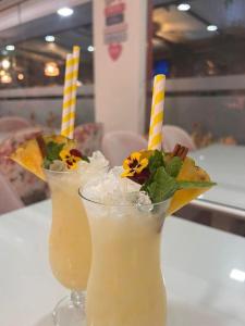two drinks sitting on a table with candles in them at Casa do Lago in Amarante +27 photos