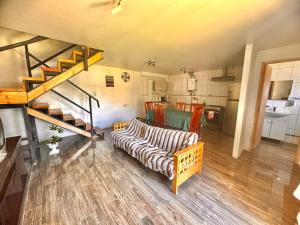 a living room with a couch and a staircase at Cabañas Drü 1 in Coihaique