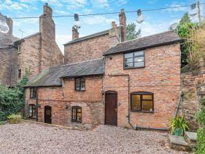 an old brick house with two chimneys at The Wild Cherry Tree Retreat in Ironbridge