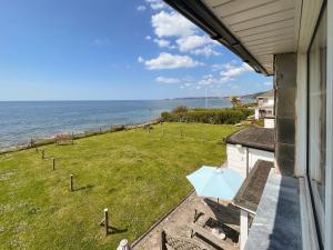 a view of the ocean from the balcony of a house at Coastguard Cottage in Downderry