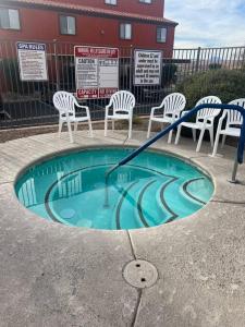 a small swimming pool with chairs at Mesquite Magic in Mesquite