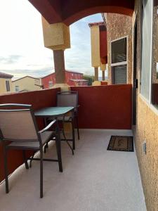 a balcony with a table and chairs on a building at Mesquite Magic in Mesquite