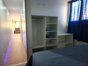a bedroom with a bed and a closet with shelves at Depto JJ in Las Heras
