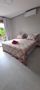 a large bed in a room with a window at White House - Taipú de Fora in Barra Grande +18 photos