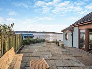 a patio with a view of a body of water at Shore House in Kilcreggan