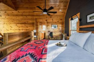 a bedroom with a bed with a ceiling fan at Updated Serene Mtn Cabin, theater rm & popcorn! in Sevierville