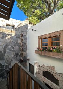 a house with a stone wall and a window at Casa Andreu in San Miguel de Allende