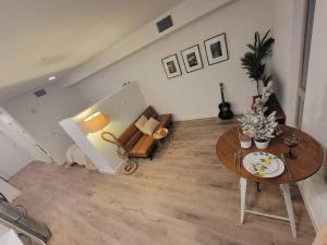 a living room with a table and a couch at Amazing big studio near Balboa Park Jacuzzi rooftop free parking! in San Diego