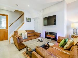 uma sala de estar com sofás e uma mesa em Wharfedale Cottage em Harrogate
