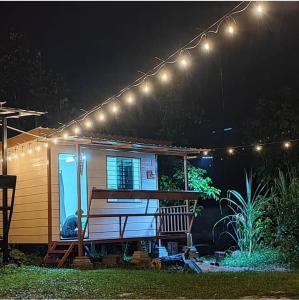 a cabin with a bench under a string of lights at Pak Long Man Roomstay in Pendang