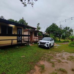 a car parked in front of a house at Pak Long Man Roomstay in Pendang