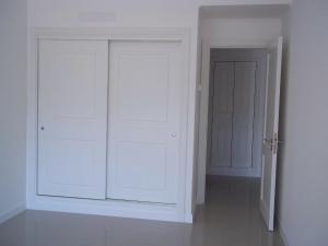 a white room with two white doors and a hallway at Green Park Punta del Este - Full Amenities in Punta del Este +11 photos
