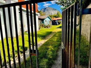 an open gate with a mountain in the background at Cabaña Antü Lautaro in Coihaique