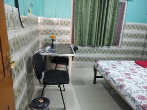 een kamer met een tafel en stoelen en een bed bij Comfort Inn Kamakhya Jn in Guwahati