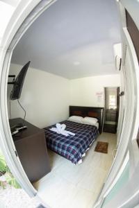 1 dormitorio con cama, escritorio y espejo en HOTEL CAMPESTRE VILLA BETEL, en Rivera