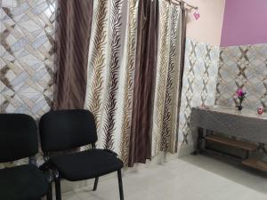 een wachtkamer met 2 stoelen en een tafel bij Comfort Inn Kamakhya Jn in Guwahati