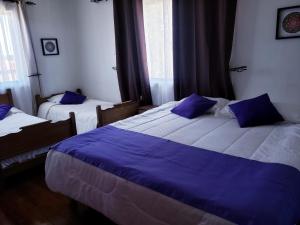 Kama o mga kama sa kuwarto sa Hostal Arrayan