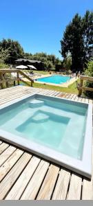 a large swimming pool on a wooden deck at Terra Newen Pucon Family Suites in Pucón