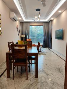 a dining room with a table and chairs at Aura Home Stay in Mohali