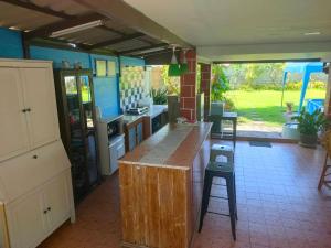 a kitchen with a counter and a stool in it at PRAN Sea & Sun1 in Ban Pak Nam Pran