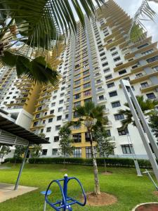 a large building with a palm tree and a playground at Chahya Embun @Putrajaya in Putrajaya