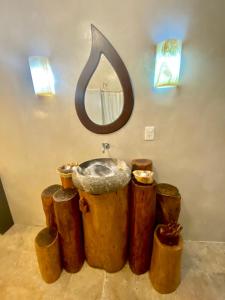 a bathroom with a sink and a bunch of trash cans at Casa Nuup Holbox in Holbox Island