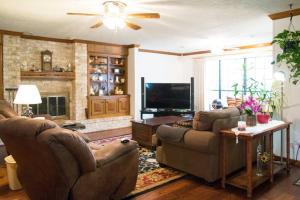 a living room with two couches and a flat screen tv at 2 room luxury suite near airport & The Woodlands in Houston