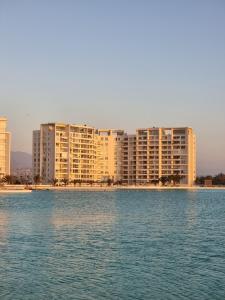 vistas a un gran complejo de apartamentos desde el agua en Departamento Laguna del Mar, en La Serena