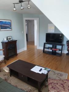 a living room with a couch and a table at 2 bedroom apartment in historical home in Barrie