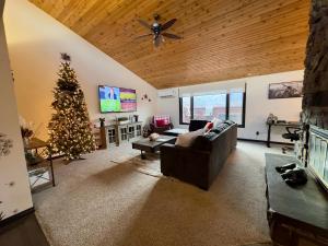 a living room with a christmas tree and a couch at Indoor pool, hot tub, sauna! in Colorado Springs
