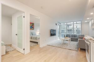 a white living room with a bed and a couch at Cozy 2BR Close to CN Tower & Harbourfront in Toronto