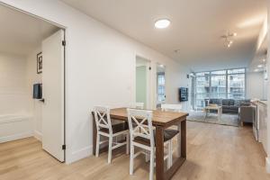 a kitchen and dining room with a table and chairs at Cozy 2BR Close to CN Tower & Harbourfront in Toronto