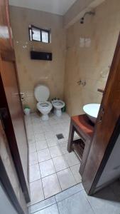 a bathroom with a toilet and a sink at El Fortin in Mar del Plata