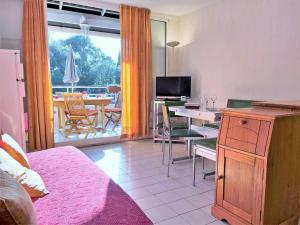 a living room with a table and a dining room at Appartement Le Lavandou, 3 pièces, 6 personnes - FR-1-251-534 in Le Lavandou
