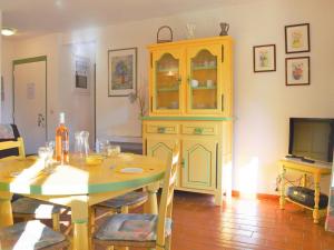 a dining room with a table and a cabinet at Appartement Le Lavandou, 2 pièces, 4 personnes - FR-1-251-573 in Le Lavandou