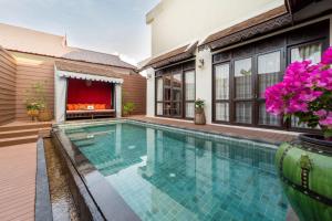 a swimming pool in the backyard of a house at Puripunn Hideaway in Chiang Mai