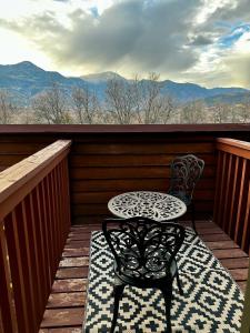 a table and chair on a balcony with a view at Indoor pool, hot tub, sauna! in Colorado Springs