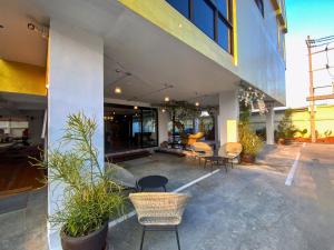 a patio of a building with chairs and tables at Goldsmith Bangkok Residence in Bangkok