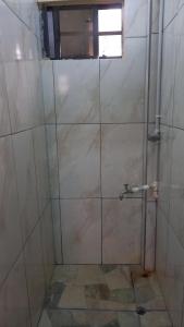 a shower with a glass door in a bathroom at Liz One Stop Apartment in Georgetown