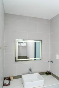 a white bathroom with a sink and a mirror at Hai Duong Vung Tau Hotel - Khách sạn Hải Dương Vũng Tàu in Vung Tau