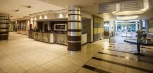 a lobby with a column in a building at Garden Court Sandton City in Johannesburg +65 photos