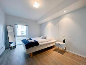 A bed or beds in a room at Unique Place by Stavanger BnB 19 (2BR, Terrace, Parking/Airport Shuttle)