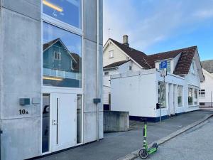 a scooter parked in front of a building at Unique Place by Stavanger BnB 19 (2BR, Terrace, Parking/Airport Shuttle) in Stavanger