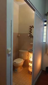 a bathroom with a toilet in a room at Hotel el Calvario in Zapotitlán Salinas