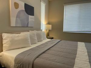 um quarto com uma cama grande e almofadas brancas em Stylish Modern 3bd-2ba With Amenities em Daytona Beach