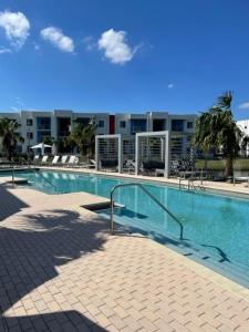 a large swimming pool in front of a building at Stylish Modern 3bd-2ba With Amenities in Daytona Beach
